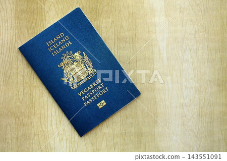 Icelandic passport on table close up. Official identification document book for citizens of Iceland. Concept of travel and tourism in Iceland 143551091