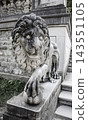 Marble statue of lion holding a ball in its paws. Regal lion leaning on empty heraldic shield 143551105