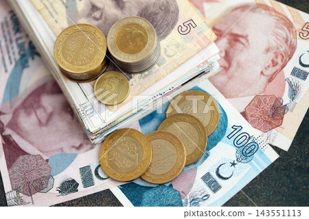 Turkish lira money bills and kurus coins pile on table. Turkey coins on banknotes of TRY currency close up. Concept of business, taxes and banking in Turkey 143551113