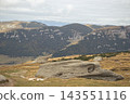 Mountains in the clouds, hills with green grass rocks. Awesome alpine scenery with mountains 143551116