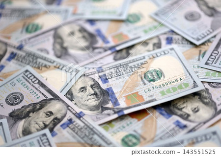 Money background with Franklin on the 100-dollar note. Texture of US dollar currency and banknotes Money background with Franklin on the 100-dollar note. Texture of US dollar currency and banknotes 143551525