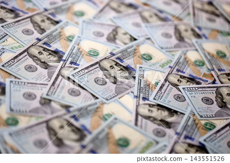 Stacks of hundred dollar bills showcase intricate designs on a flat surface. Money background 143551526