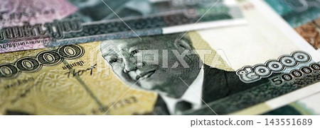 Cambodian riel money bills pile on table. Cambodia banknotes of KHR currency close up Cambodian riel money bills pile on table. Cambodia banknotes of KHR currency close up 143551689