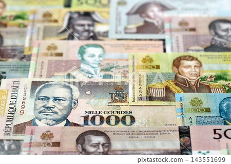 Haitian gourde money bills pile on table. Haiti banknotes of HTG currency. Concept of business Haitian gourde money bills pile on table. Haiti banknotes of HTG currency. Concept of business 143551699