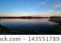 Calm Waterway at Dusk With Distant Shoreline 143551789
