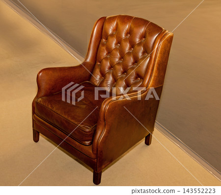 Brown leather armchair inside room Brown leather armchair inside room 143552223