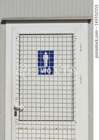 Public toilet door with blue sign and protective metal grid Public toilet door with blue sign and protective metal grid 143552553