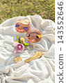 Minimalist still life with wine, dried fruits and edible flowers in soft sunlight. 143552646