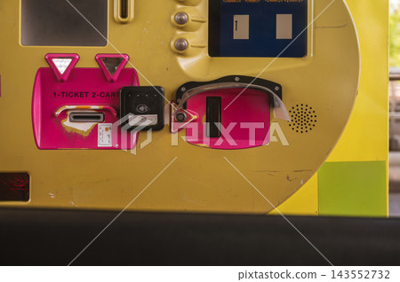 Toll payment machine with ticket and card options close up. Close up of toll payment machine displaying ticket and card options in bright colors, automated kiosk at paid road entrance for cashless veh 143552732