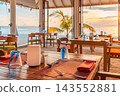 Elegant overwater restaurant set tables ocean view terrace palms bright tropical resort dining scene. Luxury five star hospitality retreat. Exclusive refined ambience 143552881