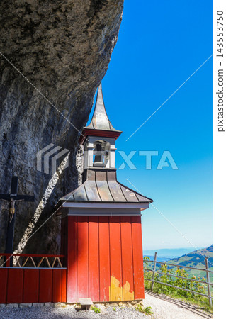 The historic wooden cliff chapel of Wildkirchli built into a mountain cave in the Alpstein region, Switzerland The historic wooden cliff chapel of Wildkirchli built into a mountain cave in the Alpstein region, Switzerland 143553750