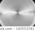 Brushed metal surface with concentric circular grain radiating from center and a bright horizontal light streak, dark vignette at corners 143553781