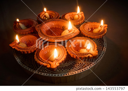 Glowing clay diyas illuminating traditional hindu diwali festival 143553797