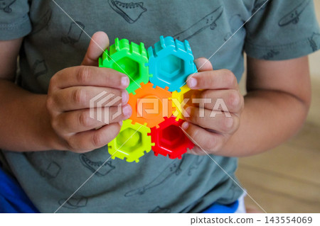 Child playing with colorful construction toy, early education, STEM learning and fine motor skills concept 143554069
