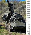 CAESAR Self-Propelled Howitzer Standing in an Open Field with Gun Barrel Elevated 143554435
