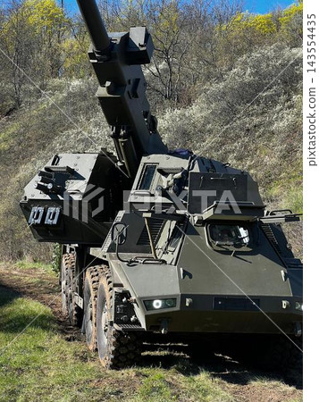 CAESAR Self-Propelled Howitzer Standing in an Open Field with Gun Barrel Elevated CAESAR Self-Propelled Howitzer Standing in an Open Field with Gun Barrel Elevated 143554435
