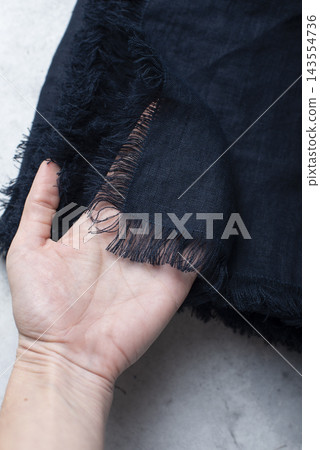 Hand Holding Fringed Edge Dark Navy Blue Linen Tablecloth Hand Holding Fringed Edge Dark Navy Blue Linen Tablecloth 143554736
