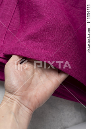 Hand Holding Hemmed Edge Fuchsia Pink Linen Tablecloth Hand Holding Hemmed Edge Fuchsia Pink Linen Tablecloth 143554753