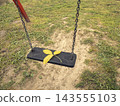 Empty Playground Swing With Yellow Fallen Leaf On Black Seat In Autumn Park 143555103