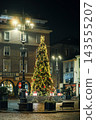 Illuminated Christmas tree and street lanterns at night in historic town square of Asti, Italy 143555207