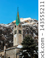 Alpine church belfry against snow covered mountains in Gressoney-Saint-Jean, Aosta Valley, Italy 143555211
