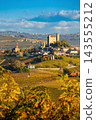 Vertical view of Serralunga d'Alba medieval town on hilltop surrounded by autumn vineyards in Italy 143555212