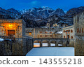 Illuminated Forte di Vinadio fortress at dusk in winter with snow and snow-capped mountains in Italy 143555218