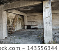 Inside a concrete ruin with a steel staircase 143556344