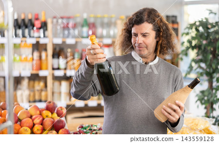 Adult man chooses wine or champagne 143559128