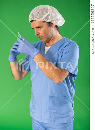 Adult male medic explaining injection procedure with syringe on green screen Adult male medic explaining injection procedure with syringe on green screen 143559207