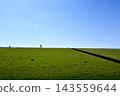 A senior man walking along the Yodogawa River embankment. 143559644