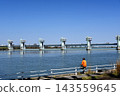 A man enjoying fishing in front of the Yodogawa Kema Auction Gate. 143559645