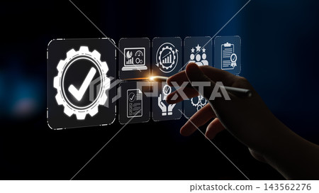 A hand interacting with digital quality management icons, symbolizing innovation and success in business strategies and performance optimization on a sleek abstract background. Sigmoid A hand interacting with digital quality management icons, symbolizing innovation and success in business strategies and performance optimization on a sleek abstract background. Sigmoid 143562276
