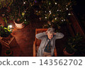 Senior woman relaxing alone on terrace during peaceful evening. 143562702