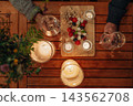 Senior couple enjoying romantic dinner together on terrace at night. 143562708