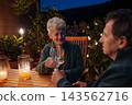 Loving senior couple enjoying romantic evening together on terrace. 143562716