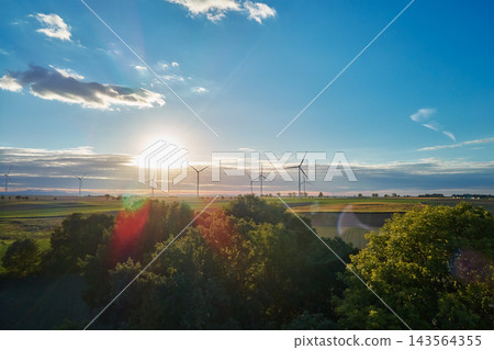 Wind turbines over rural fields at sunset Wind turbines over rural fields at sunset 143564355