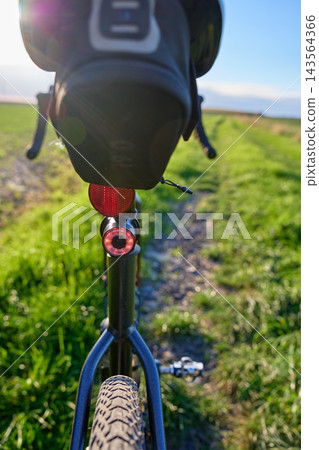 Rear bicycle light and saddle bag on gravel bike outdoors Rear bicycle light and saddle bag on gravel bike outdoors 143564366
