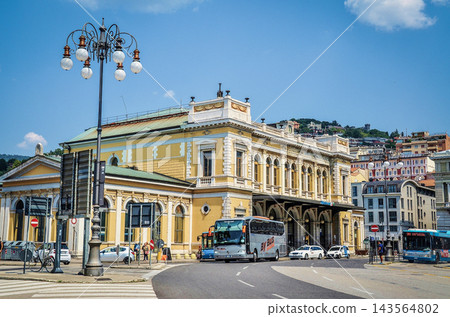 公車從的里雅斯特中央火車站黃色月台前駛過,背景是藍天。 公車從的里雅斯特中央火車站黃色月台前駛過,背景是藍天。 143564802