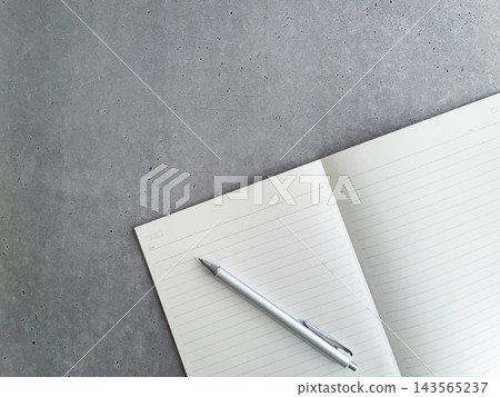 A flat lay of an open notebook and ballpoint pen. A flat lay of an open notebook and ballpoint pen. 143565237