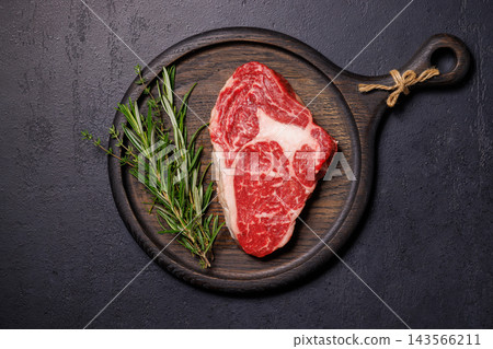 Butcher cut beef with salt pepper and fresh thyme - beside a carving knife Butcher cut beef with salt pepper and fresh thyme - beside a carving knife 143566211