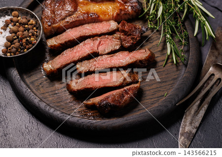Medium rare beef steak with thyme and peppercorns - with a caramelized crust Medium rare beef steak with thyme and peppercorns - with a caramelized crust 143566215