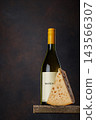 White wine bottle with cheese on rustic table 143566307
