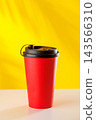 Red takeaway coffee cup on yellow background 143566310
