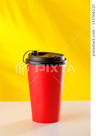 Red takeaway coffee cup on yellow background 143566310