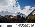 Snow covered mountains under blue sky 143566316