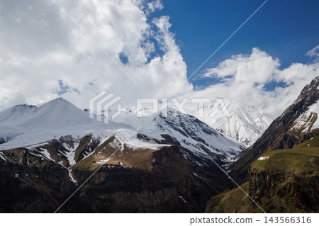 Snow covered mountains under blue sky Snow covered mountains under blue sky 143566316