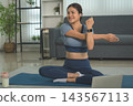 Active Asian Woman Exercising, Stretching and Tracking Fitness During a Healthy Home Workout 143567113