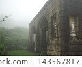 An old building shrouded in mist, creating a fantastical atmosphere. 143567817