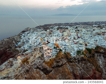 Aerial Drone View of Oia, Santorini. A breathtaking aerial view of the whitewashed village of Oia, Santorini, showcasing luxury resorts with infinity pools overlooking the Aegean Sea. A stunning blend Aerial Drone View of Oia, Santorini. A breathtaking aerial view of the whitewashed village of Oia, Santorini, showcasing luxury resorts with infinity pools overlooking the Aegean Sea. A stunning blend 143568041